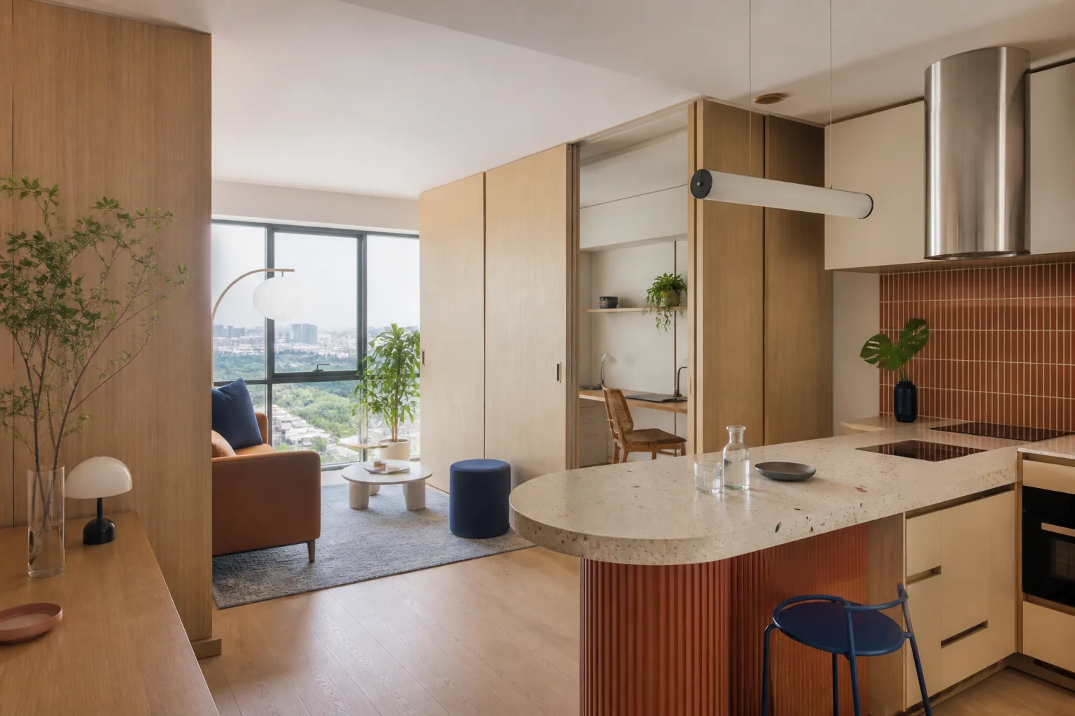 Compact apartment with movable oak partitions and a curved terrazzo island